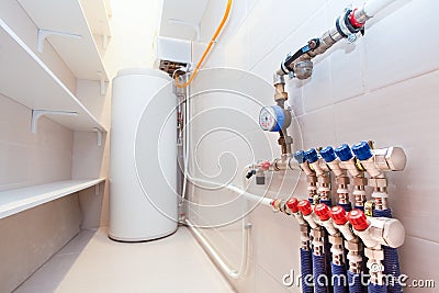 Copper valves, stainless ball valves and plastic pipes on a boiler room equipment in apartment during under renovation, remodeling Stock Photo