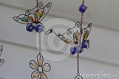 Copper wire, blue marble and colorful beads shaped into butterflies and a flower Stock Photo