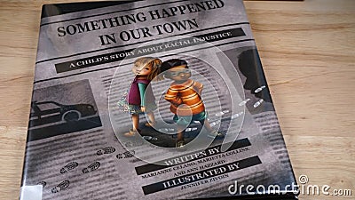 A copy of the children`s book Something Happened in Our Town: A Child`s Story about Racial Injustice Editorial Stock Photo