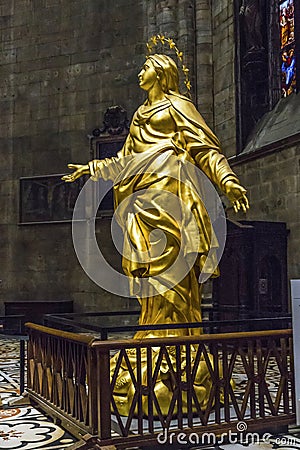 A copy of the gilded sculpture of La Madonnina in the apse of the Milan Cathedral Editorial Stock Photo