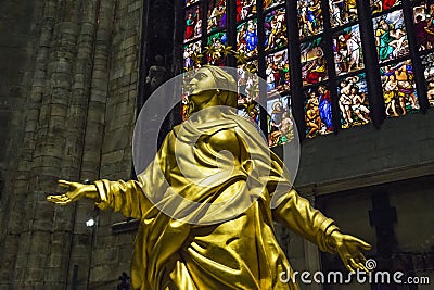 A copy of the gilded sculpture of La Madonnina in the apse of the Milan Cathedral Editorial Stock Photo