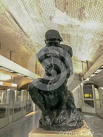 Copy of Rodin`s The Thinker in the Metro station Varenne, Paris, France Editorial Stock Photo