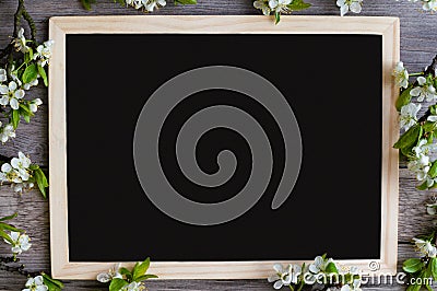 Copy space on a black blackboard for your creative with beautiful branches of plum. Stock Photo