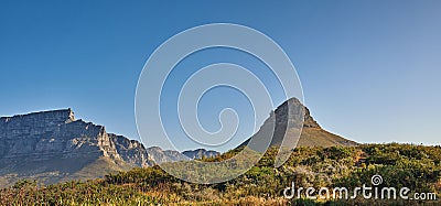 Copy space, landscape view and mountains of Lions Head and Table Mountain in serene, relaxing nature reserve. Blue sky Stock Photo