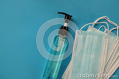 Copy space Medical mask and alcohal gel for protecting infection during Coronavirus on blue background Stock Photo