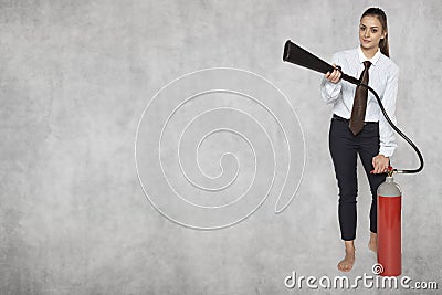 Copy space next to the businesswoman which holds fire extinguish Stock Photo