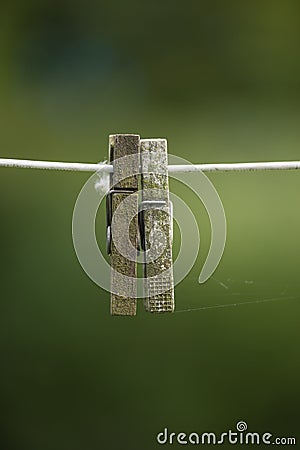 Copy space of old clothespins hanging on abandoned washing or laundry line with bokeh outside. Closeup of spiderwebs Stock Photo