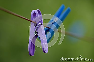 Copy space of plastic clothespins hanging on washing cable or laundry line with bokeh outside. Closeup of neglected Stock Photo