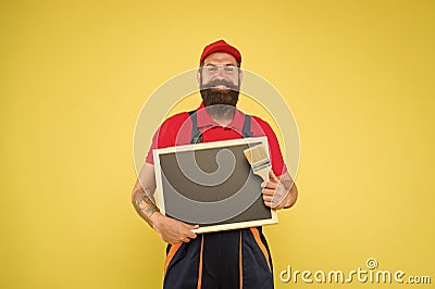 Copy space. professional repairer wanted. builder man paint on blackboard. bearded worker painting brush. brutal builder Stock Photo