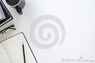 Copy space table with book, coffee cup, pencil,notebook and glasses on desk. Stock Photo