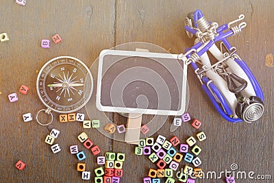 copy space of word block,compass and handcrafted souvenir on wooden background Stock Photo