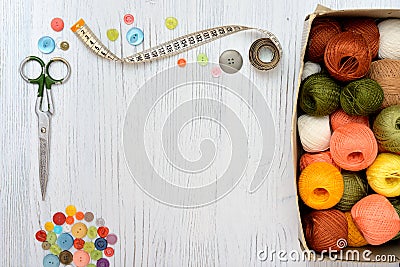 Copyspace frame with sewing tools and accesories on white wooden background Stock Photo