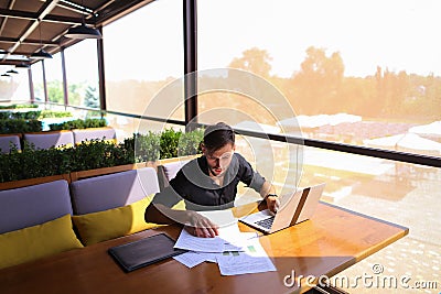 Copywriter typing text on laptop at cafe table. Stock Photo