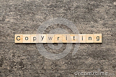 Copywriting word written on wood block. Copywriting text on cement table for your desing, concept Stock Photo