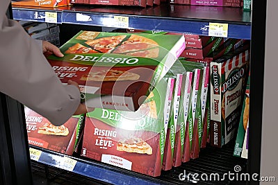 Motion of woman buying pizza inside Walmart store Editorial Stock Photo