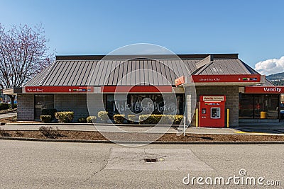 COQUITLAM, CANADA - MARCH 31, 2019: Shopping mall in city center with Vancity credit union and parking lots Editorial Stock Photo