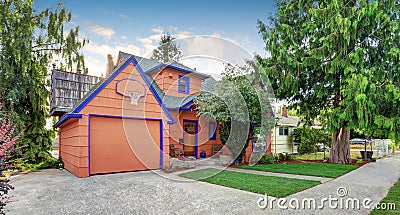 Coral exterior American house with blue trim with garage. Stock Photo