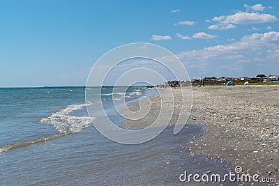 Corbu, Constanta, Romania - August 18, 2019: The beach in Corbu with tourists in the background, Romania Editorial Stock Photo