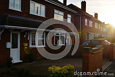 Corby, England. November 13 - Brick village traditional houses at sunset. Stock Photo