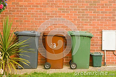 Corby, United Kingdom, 20 june 02019 - wheelie bin in front of a house, brick wall Editorial Stock Photo