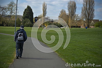 Corby, United Kingdom. March 13, 2019 - Old man walking in the autumn park. Copy space Editorial Stock Photo