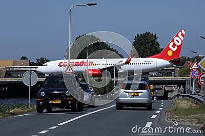 Corendon plane taxiing over bridge in Schiphol Airport, AMS Amsterdam, close-up view Editorial Stock Photo