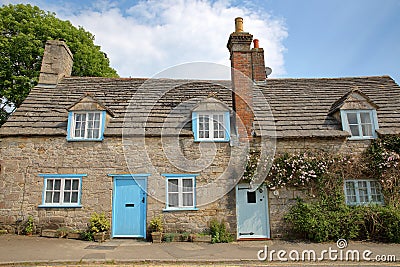 CORFE CASTLE, UK - MAY 21, 2018: The main facade of a medieval house with brickstone and flagstone roof in Corfe Castle village Editorial Stock Photo