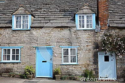 CORFE CASTLE, UK - MAY 21, 2018: The main facade of a medieval house with brickstone and flagstone roof in Corfe Castle village Editorial Stock Photo