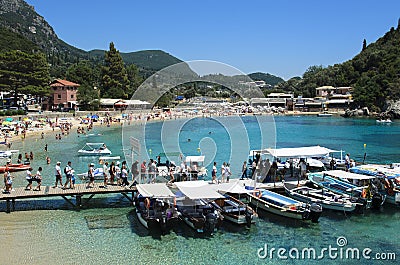 Tourists on the pier waiting to be boarded on boats, on the bottom the green and turquoise sea, Editorial Stock Photo