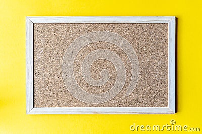 A cork board is a framed section of cork backed with wood or plastic. Stock Photo