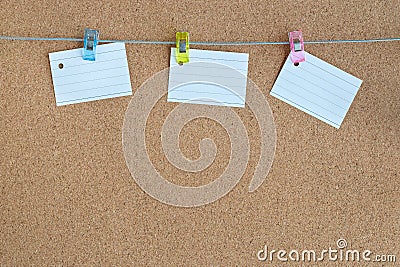 Cork memory board with blank peaces of paper hanging on rope with clothes pin, horizontal Stock Photo