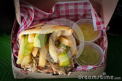 Corn arepas stuffed with beef, chicken breast, pork ham, mozzarella cheese and avocado Stock Photo