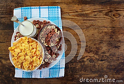 Corn flakes and glass of milk on old wooden table Stock Photo