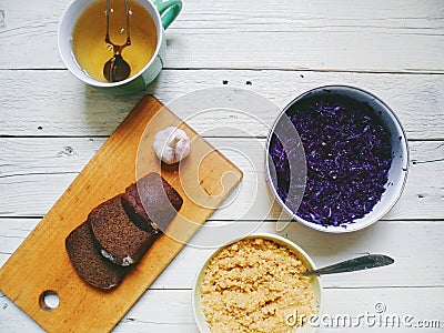 corn porridge, salad of red cabbage, bread and a cup of green tea Stock Photo