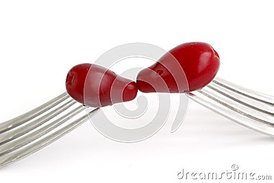 Cornelian Cherry Cornus mas on fork isolated on white background Stock Photo