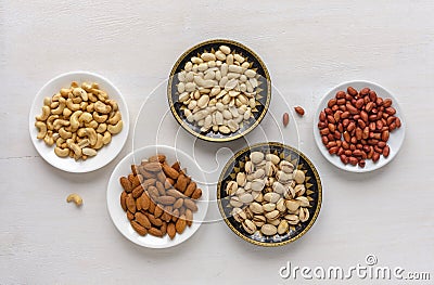Corner border of fresh nuts in bowls Stock Photo