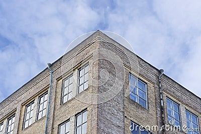 Corner of a building against a blue sky in the spring. Stock Photo