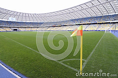 Corner flag on a football field of a stadium and empty stands Editorial Stock Photo