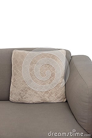 Corner fragment of beige grey upholstered couch with velour decorative cushion on white wall background. Isolated Stock Photo