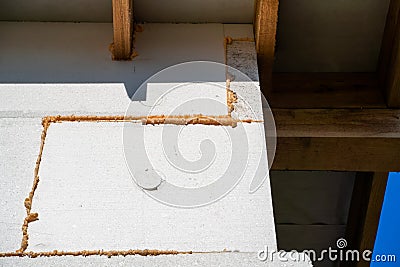 The corner of the house is insulated with polystyrene foam close-up. The wall of the house is insulated to the very roof Stock Photo