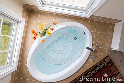 Corner oval bathtub full of clean water Stock Photo