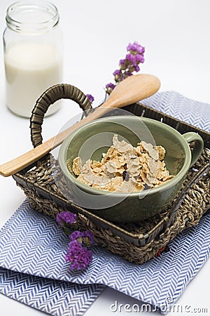 Cornflakes and a jar of milk served in a basket Stock Photo