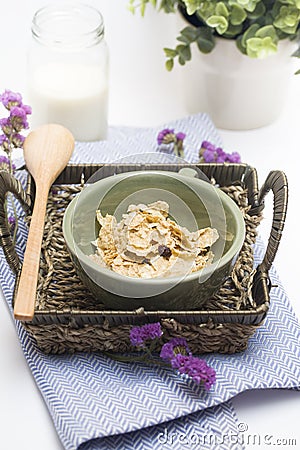 Cornflakes and a jar of milk on the table Stock Photo