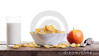 Cornflakes with milk and apple on wooden table Stock Photo