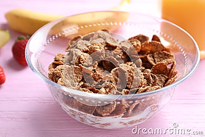 Cornflakes on pink wooden table. Healthy breakfast Stock Photo