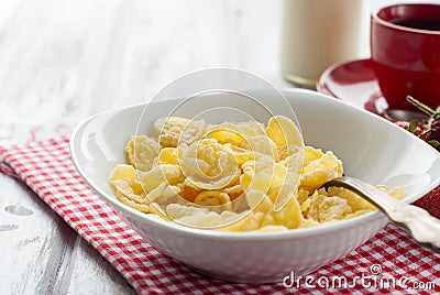 Cornflakes, strawberry, milk and a cup of coffee for breakfast Stock Photo