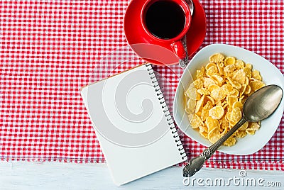 Cornflakes, strawberry, milk and a cup of coffee for breakfast Stock Photo