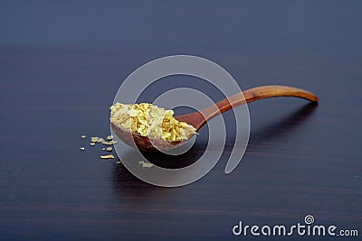 Cornflakes in wood spoon on a dark wooden Stock Photo