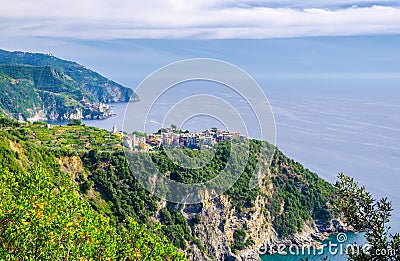 Corniglia traditional typical Italian village with colorful buildings on rock cliff and Manarola, Genoa Gulf, Ligurian Sea, blue s Stock Photo