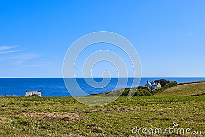 Cornish Headland with grass and sea Stock Photo